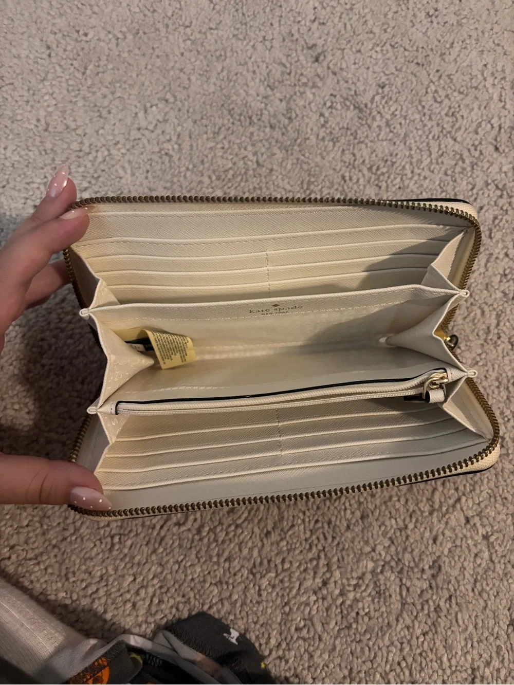 kate spade cream laser-cut floral zip-around wallet with black underlay